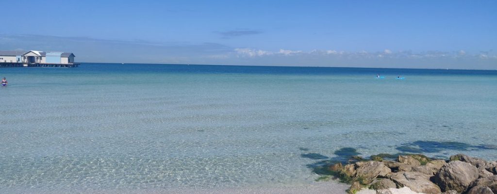 Clear turquoise Gulf water and a pier on Anna Maria Island in Manatee County, Florida