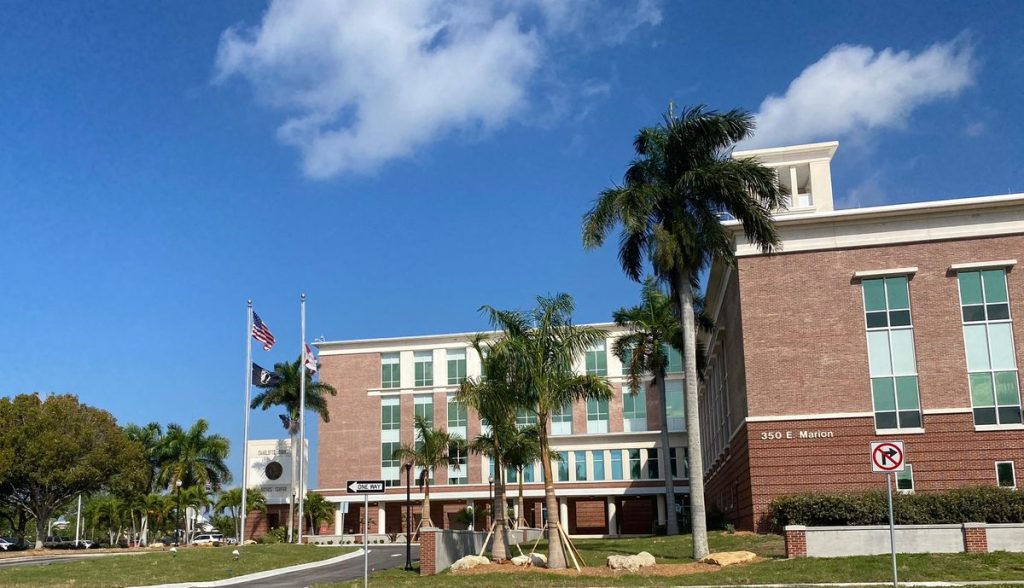 Charlotte County Justice Center in Punta Gorda, with palm trees and the U.S. and Florida flags