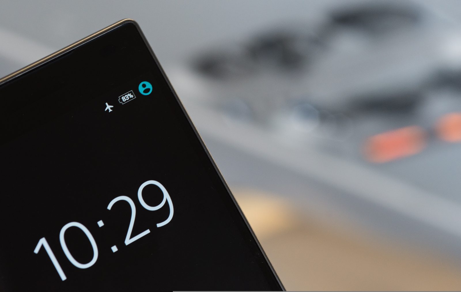 Black smartphone on a table showing the time