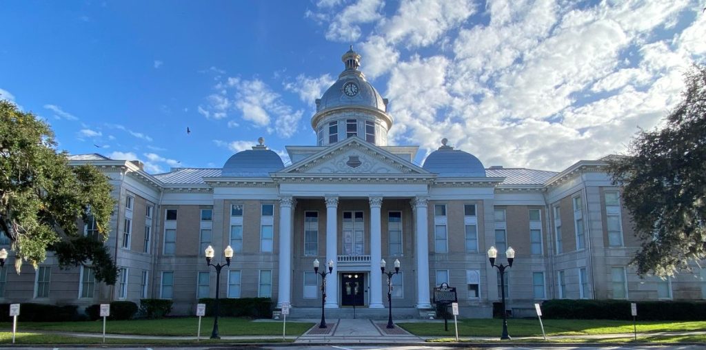 Historic former Polk County Courthouse with a silver dome and columns in downtown Bartow