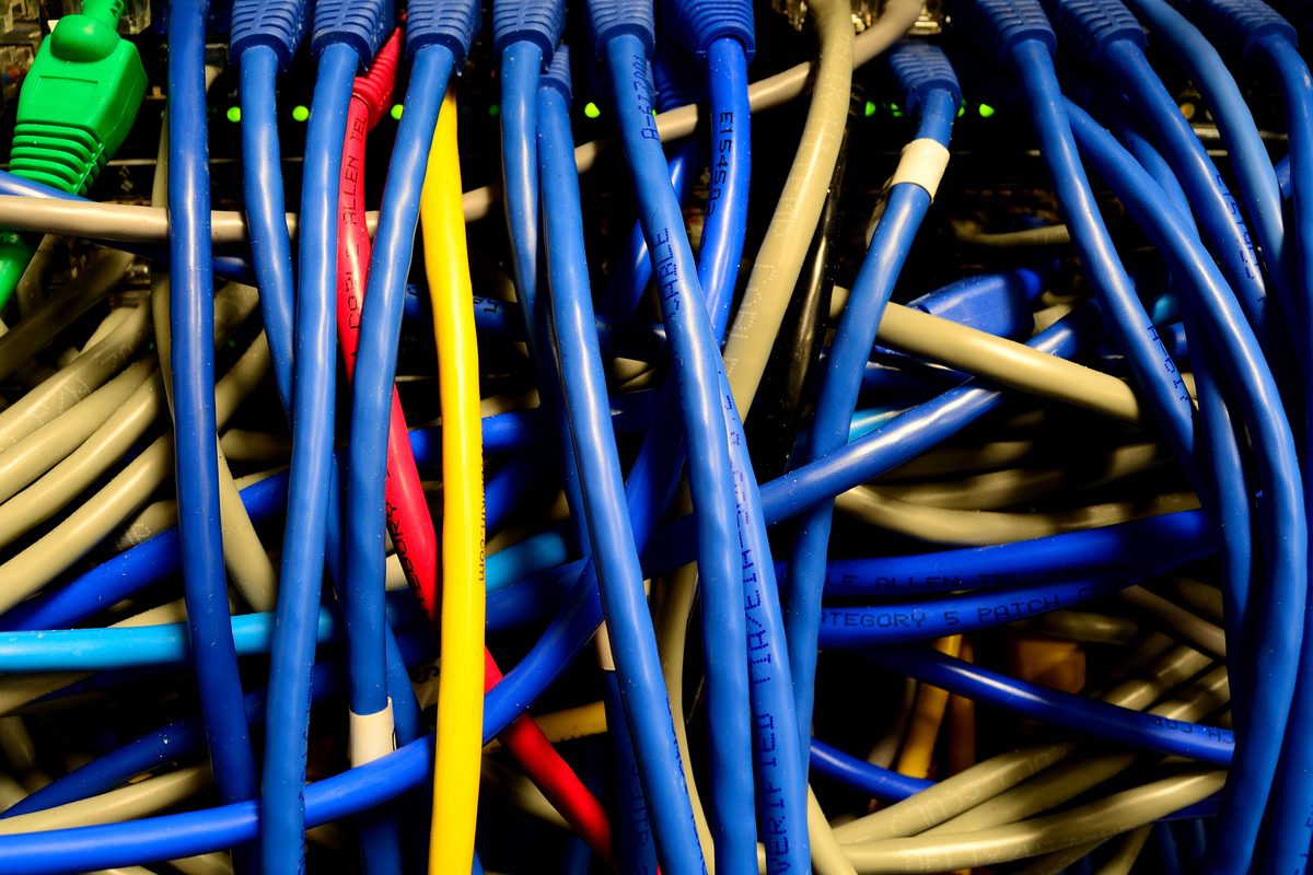 Tampa internet crime lawyer: blue, yellow, red and green network cables plugged into an ethernet switch