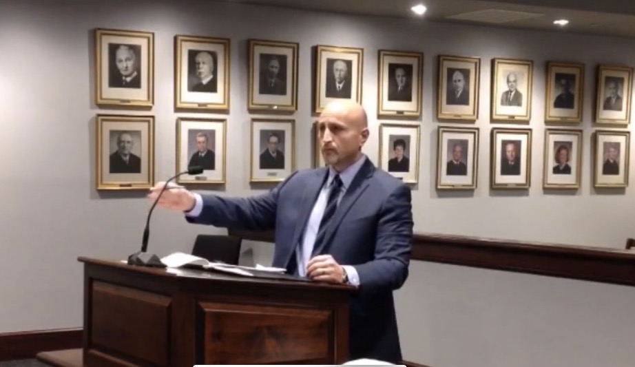 Attorney Ron Frey speaking at a podium