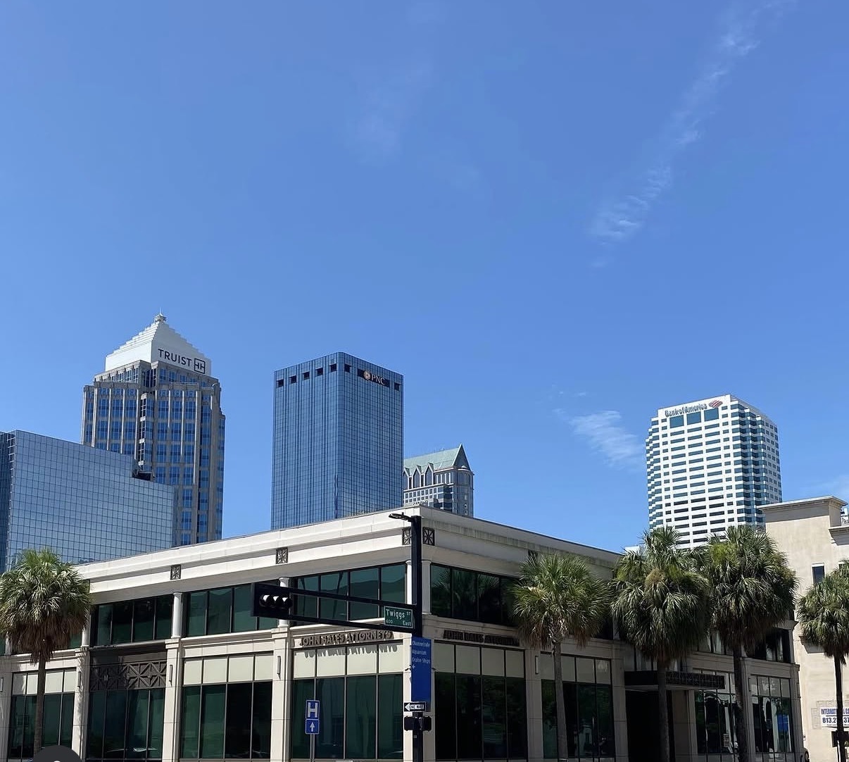 The Frey Law Firm office building on E. Twiggs St. with the downtown Tampa skyline behind it