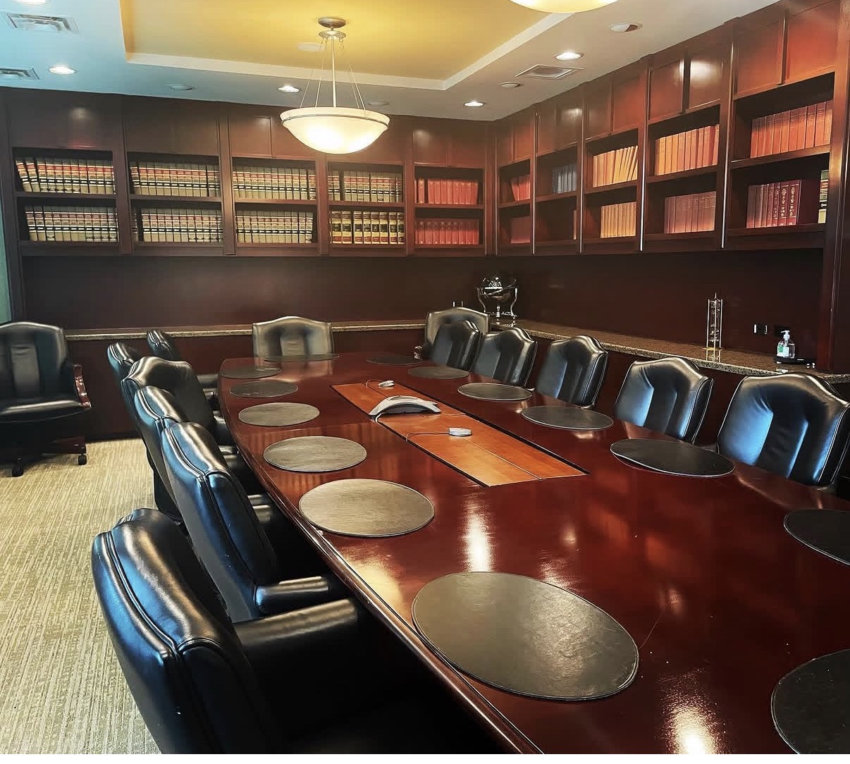 Conference room with a long wooden table and leather chairs at The Frey Law Firm