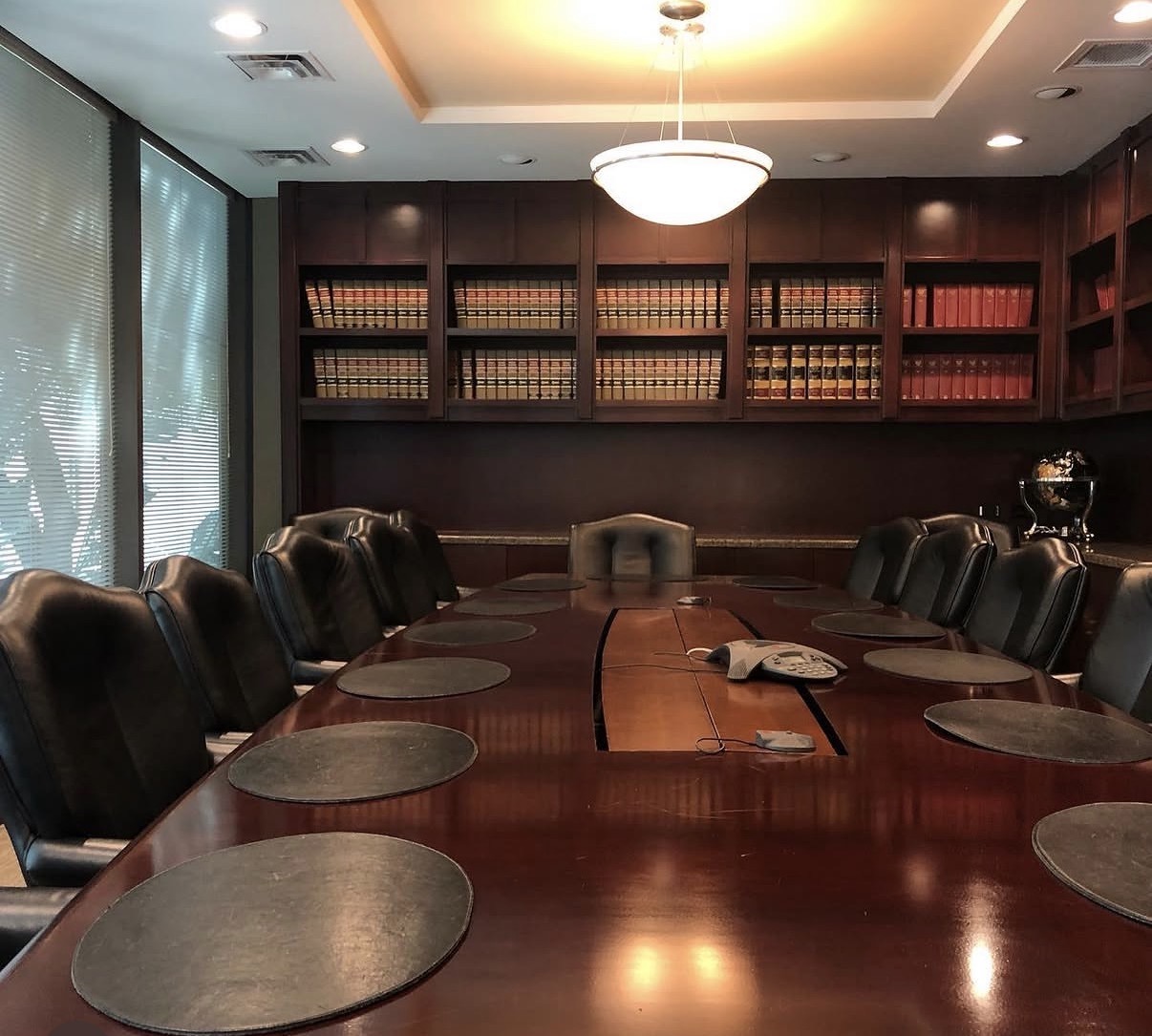Conference room with bookshelves and a wooden table at The Frey Law Firm