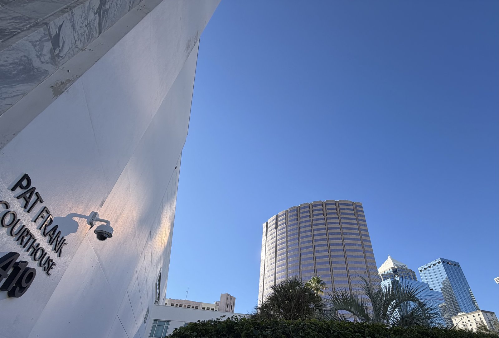 The Pat Frank Courthouse sign at 419 Pierce Street with downtown Tampa towers behind it, photographed by Attorney Ron Frey.