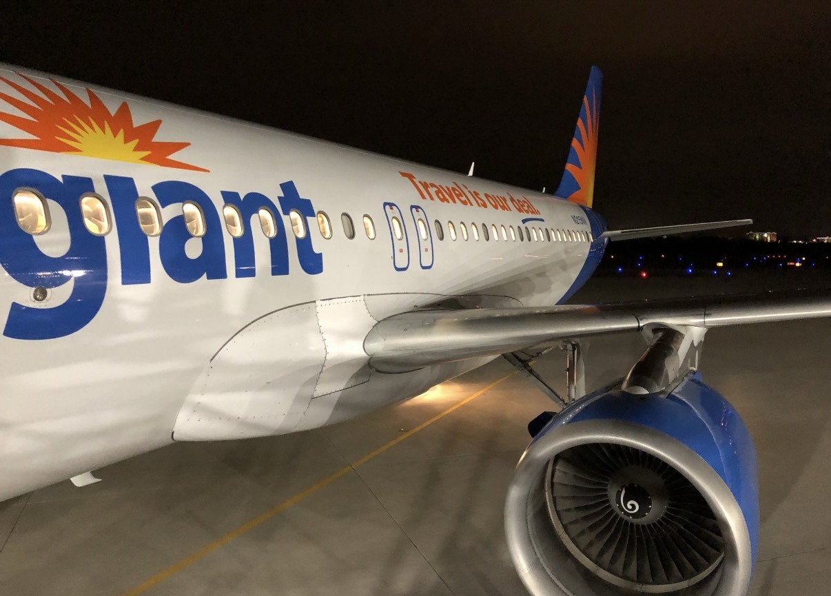Allegiant jet on an airport ramp at night