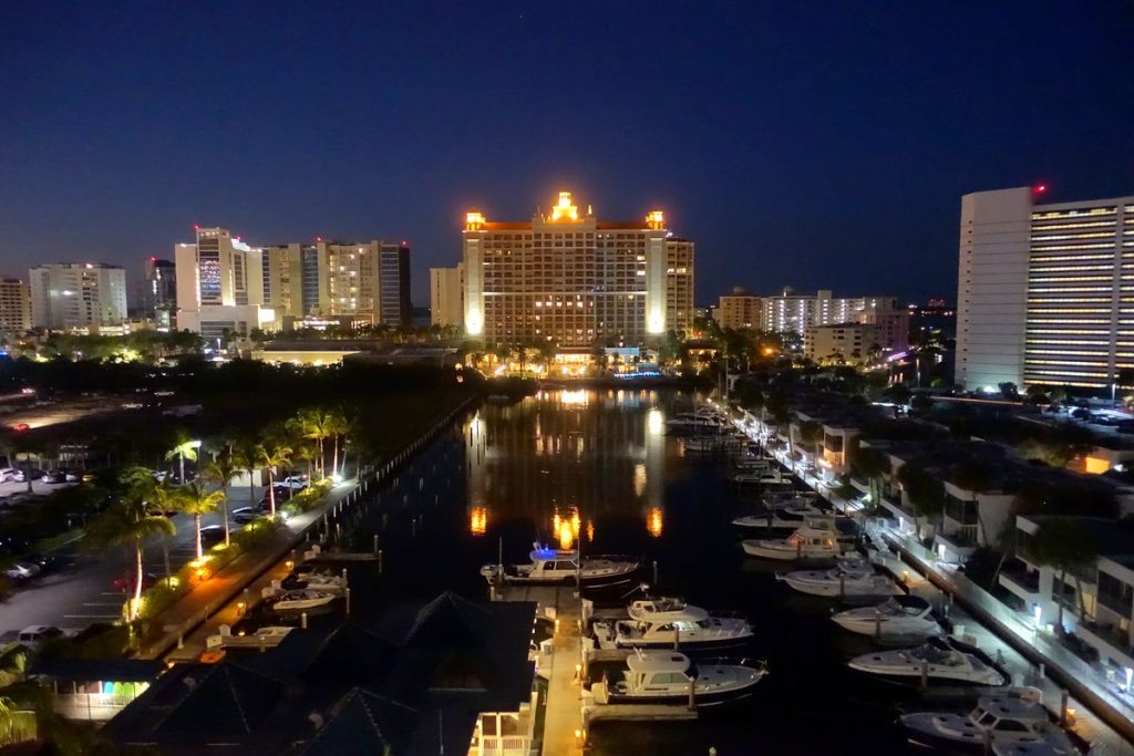Sarasota high-rises and a marina full of boats, lit up at night