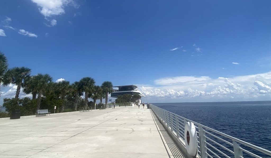 Palm-lined walkway on the St. Pete Pier stretching out into Tampa Bay in St. Petersburg, Florida
